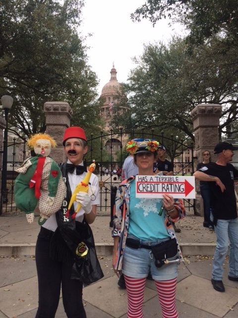 Two clowns in front of the Austin capitol