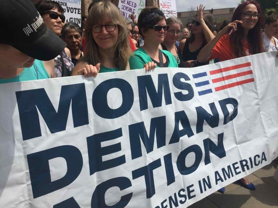 Members of the Resistance Choir of South Central Texas hold a Moms Demand Action Banner